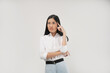 © Illhamt - A young Asian woman in a white shirt places her hand near her head, appearing to thinking attentively. Isolated on white backgorund