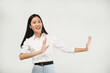 © Illhamt - An Asian woman in a white blouse stretches her arms outward with a warm smile, conveying welcome or openness. The white background keeps the focus on her approachable gesture.