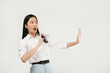 © Illhamt - An Asian woman in a white blouse gestures 'stop' with both hands and a playful smile. She combines confidence and humor against a clean white background.