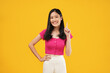 © Illhamt - Photo of young Asian woman pointing up to copy space and looking up to copy space with smile face Pretty girl act like a satisfied product, use for advertising with isolated on yellow background