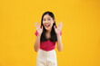© Illhamt - Excited asian woman shout out loud wow with hands on isolated background. Happy shocked face female wow promotion advertising concept. Isolated on yellow background