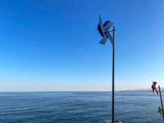 
Beach landscape with pinwheel, horizon and blue sky