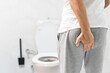 © ATRPhoto - Man suffering from hemorrhoid in rest room, man has diarrhea holding his butt in toilet, diarrhea constipation. Men have diarrhea and are looking for shit.
