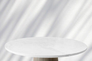 Wall Mural - Round marble table top with tree leaves shadow drop on white wall background for mockup product display