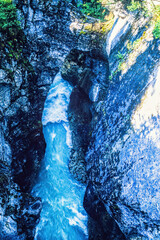 Canvas Print - Deep canyon with a flowing water from above