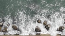 Top Down View Of Waves Crushing The Coast Line, Concrete Tetrapods.