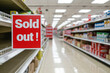 © Keitma - Sold out concept image with empty grocery store alley and shelves with red sign with written words Sold out