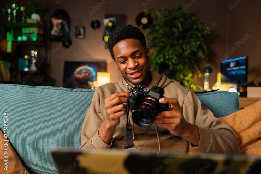 Pule Using His Camera Delighted happy African American dark skinned man filmmaker, editing ...