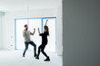 © ABCreative - Happy young family just married couple in new building home house celebrating dancing getting mortrage loan house husband and wife in debt. Investing in new apartments. Good investment