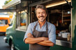 Portrait happy middle aged male smiling small business owner posing near his food truck