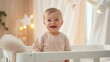 © masyastadnikova - A cute little 1-2 year old baby with blonde hair is standing in a crib and laughing. Happy childhood. Kids's emotions