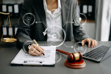 Wall Mural - Copyright or patent concept, Person hand using laptop computer, tablet and smartphone with virtual screen copyright icon trademark, Creation ownership against piracy