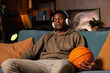 © ABCreative - Moment of relaxation basketball player taking break from rigorous training schedule simply enjoying some downtime after game or practice wearing wireless headphones listening to favorite music.