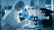 © liliyabatyrova - Scientists wearing a protective suit study dangerous substances under a microscope in a modern medical chemical laboratory. The concept of healthcare, pharmaceuticals, biotechnology, microbiology.