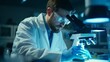 © liliyabatyrova - A handsome male doctor scientist wearing a white coat and glasses looks under a microscope, analyzes samples in a modern medical laboratory. Healthcare, microbiology, biotechnology, biology concepts.