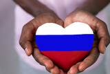 Fototapeta Tęcza - female afro hands holding a big heart with bright colors of the Russian flag, patriotic concept