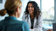 © EmmaStock - Smiling middle-aged female doctor listening to female patient talk about her health