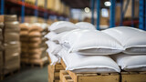 Fototapeta  - Close-up of a warehouse with bulk rice or sugar bags in a distribution center. White bag rice storage barn, bulk rice procurement, production and transportation of rice.