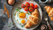 breakfast fried eggs, tomatoes and croissant on a plate