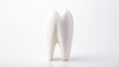  a tooth shaped toothbrush holder sitting on top of a white table next to a toothbrush dispenser.