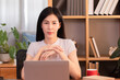 © Rakchanok - Asian freelance business owner female creative design remote work from home with technology laptop computer, employee interior design woman entrepreneur smile look at camera, businesswoman lifestyle