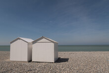 Two Lovely White Beach Huts On The Beach With Blue Sky And Ocean