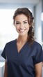 © StockGeniusPro - Successful female doctor isolated on Blurred Background wearing blue navy scrubs