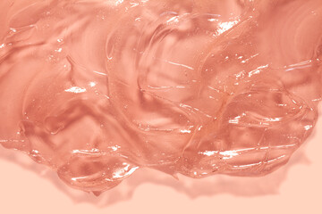 Poster - Cosmetic red peach gel or lotion or hyaluronic acid transparent gel drops texture background