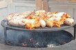 © Lidia - Fried sausages and chicken wings on barbecue grill in the village. Frying meat on open fire. Barbecue party on backyard of country house cabin. Street food festival. Home cooking outdoor. Picnic time