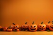 Halloween banner with isolated pumpkins over orange background. Copy space for text and design. Happy party concept