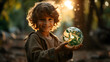 young boy holding the earth in the golden hour with sunlight coming behind