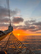 Sunrise over the Atlantic Ocean seen from the bow of a tall ship