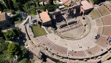 Taormina, Sicily, Italy. Cityscape Drone Aerial View. Old Greek Theatre Ruins With Active Eruption Volcano Etna Background. Popular Travel Destination In Europe, UNESCO Historical Heritage