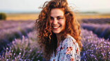 Fototapeta Lawenda - Woman with a radiant smile standing in a lavender field, countryside background generative ai