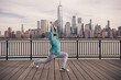Man in fitness wear exercising near Manhattan. Healthy exercises. Active senior man is fitness exercising outdoor. Exercising after retirement. Mature retired sportsman doing stretching exercises.