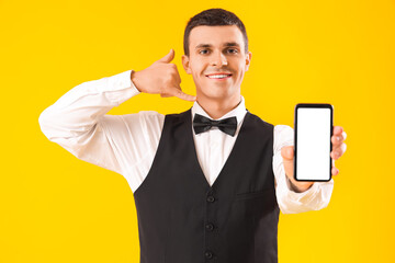 Canvas Print - Male waiter with mobile phone showing 