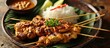 Popular Indonesian street food is chicken satay with peanut sauce and rice cake.