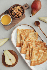 Wall Mural - Thin pancakes, homemade crepes on a plate with pear