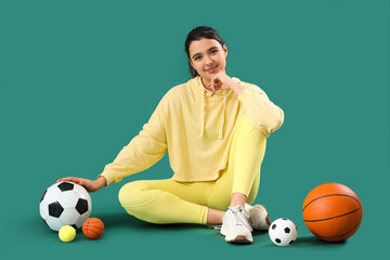 Sticker - Young woman in sportswear with balls sitting on green background