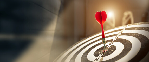 Wall Mural - Bullseye or Bulls eye target or dartboard has red dart arrow throw hitting the center of a shooting for financial business targeting planning and aim to winner goal of business concept.