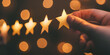 A hand placing a gold star. Customer satisfaction concept. Reviewing a business. 5 stars.