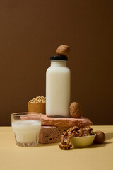 Wall Mural - Nut milk bottle without label placed on a stack of stones. All nuts have very similar macronutrient. Empty label bottle for product promotion with front view
