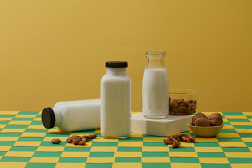 Wall Mural - Many types of organic nuts are displayed with three milk bottles. Soybean oil is the vegetable oil extracted from the seeds of the soybean