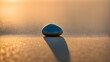 Single shining pebble centered on a vast, barren beach, minimalistic composition, captures essence of solitude