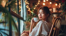 Happy Asian Woman Relaxing Drinking Hot Coffee Or Tea In Holiday Morning Vacation On Armchair At Home, Cosy Scene, Smiling Pretty Woman Drinking Hot Tea In Autumn Winter