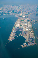 Aerial top view container ship for export and import in Indonesia taken from commercial airplane. Global business and logistic. Expedition, transportation and logistic business concept.