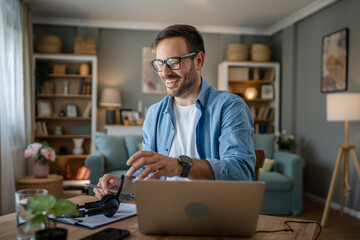 Wall Mural - one man adult caucasian work on laptop at home happy smile