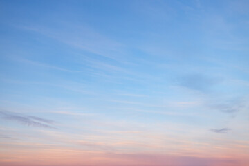Wall Mural - a beautiful sky tinted by the sun leaving vibrant shades of gold, pink, blue and multicolored. cloud