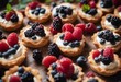 Tasty berry tartlets or cake with cream cheese and different berries around Pastry dessert top view