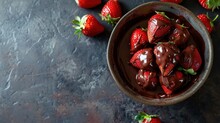  A Bowl Filled With Chocolate Covered Strawberries On Top Of A Black Table Next To A Pile Of Strawberries.